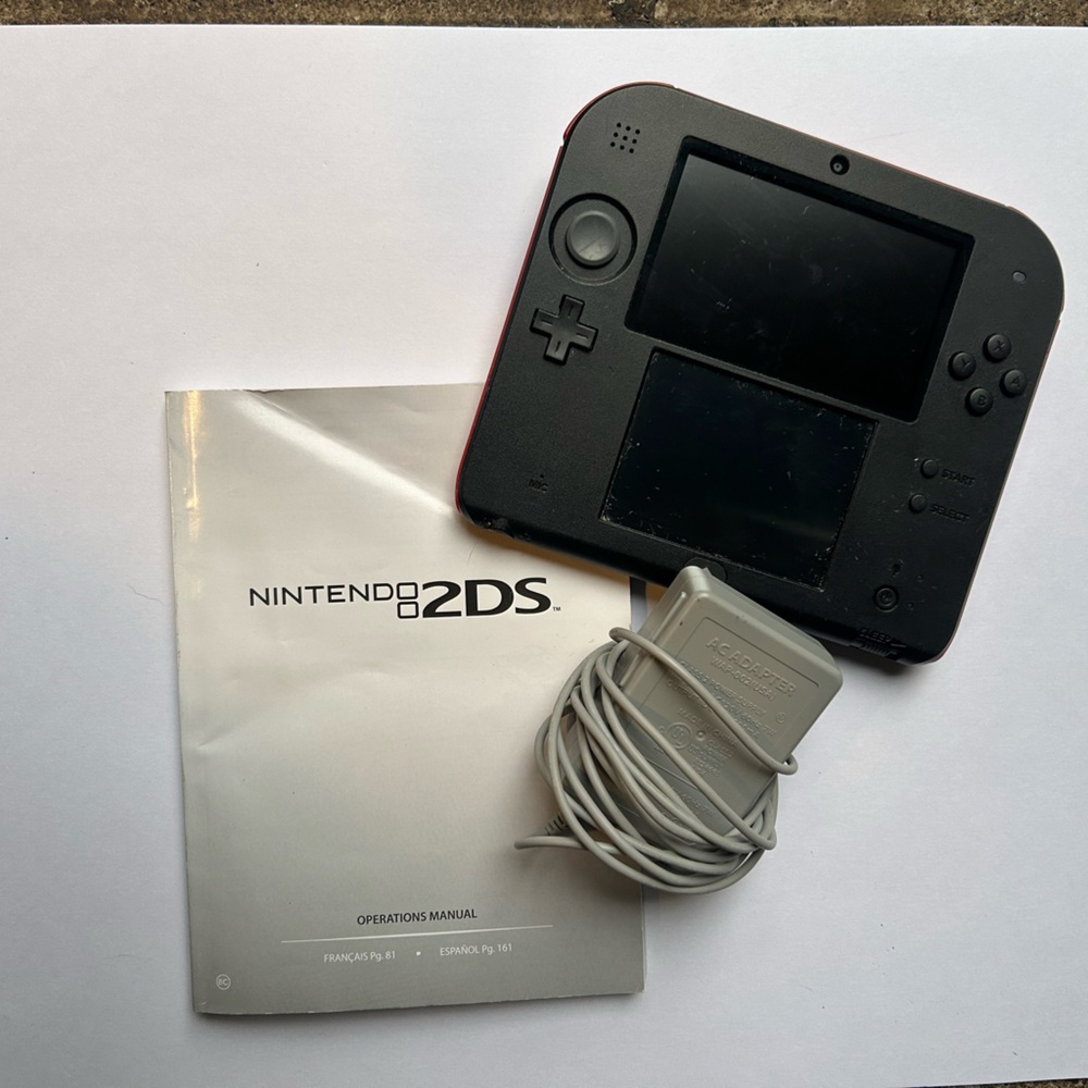 Nintendo 2DS with stylus, SDHC card, adapter and operation manual. Like new